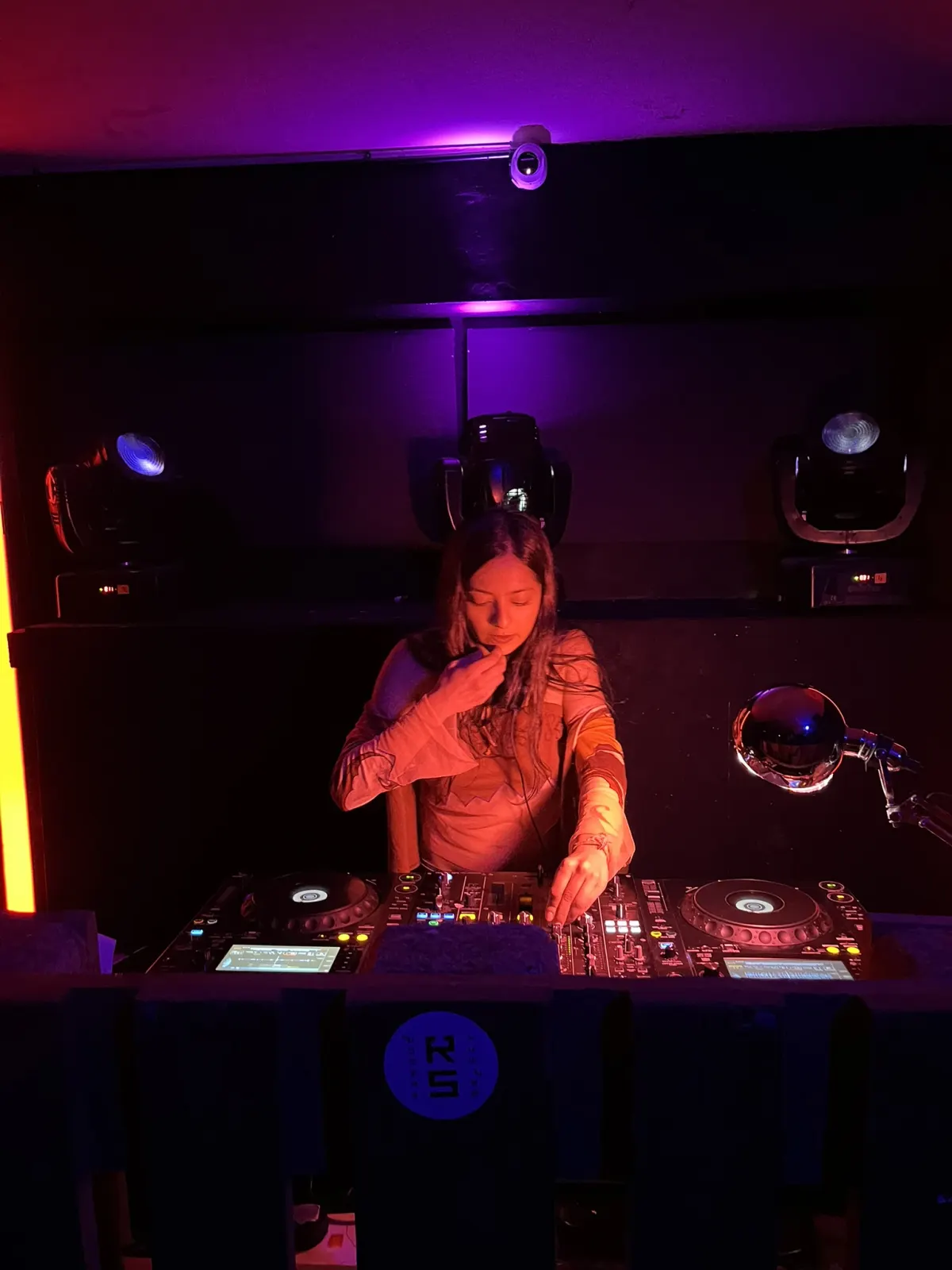 DJ under red and violet light at Daytrip × Mayhem